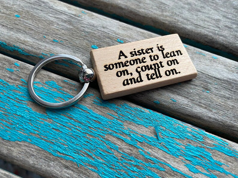 Quote Keychain- "A sister is someone to lean on, count on and tell on." -Wood Keychain