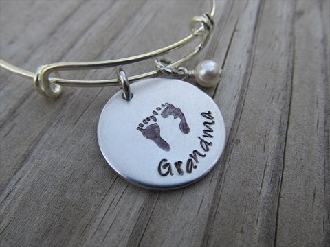 Grandma Bracelet- "Grandma" with stamped baby feet-  Hand-Stamped Bracelet- Adjustable Bangle Bracelet with an accent bead of your choice