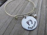 Grandma Bracelet- "Grandma" with stamped baby feet-  Hand-Stamped Bracelet- Adjustable Bangle Bracelet with an accent bead of your choice