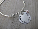 Thrive in Adversity Bracelet- "thrive in adversity" - Hand-Stamped Bracelet- Adjustable Bangle Bracelet with an accent bead of your choice