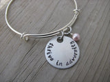 Thrive in Adversity Bracelet- "thrive in adversity" - Hand-Stamped Bracelet- Adjustable Bangle Bracelet with an accent bead of your choice