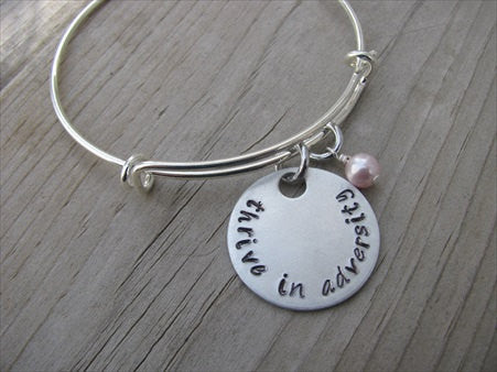 Thrive in Adversity Bracelet- "thrive in adversity" - Hand-Stamped Bracelet- Adjustable Bangle Bracelet with an accent bead of your choice