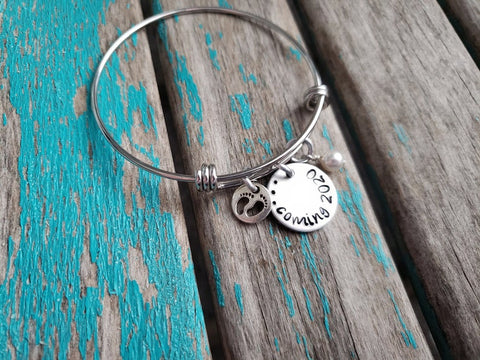 Expectant Mother Bracelet Gift- "...coming (year of your choice)"- with baby feet charm - Hand-Stamped Bracelet with an accent bead in your choice of colors